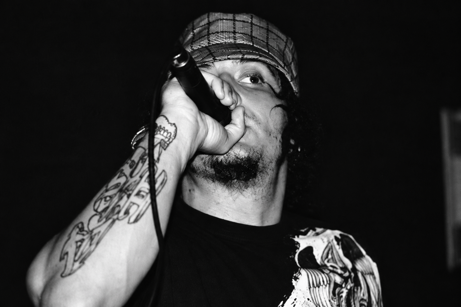 Black-and-white close-up of Bear the Astronot performing with a microphone